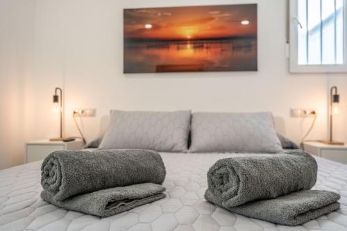 a bedroom with a bed with towels on it at Duplex-Port-Valencia in Valencia