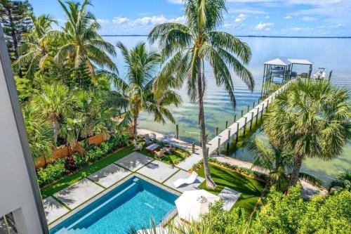 an aerial view of a swimming pool and the ocean at One Palm in South Cocoa Beach