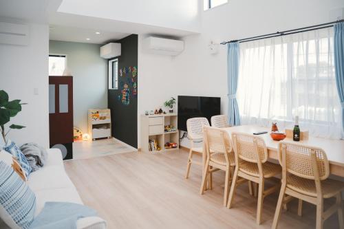 a dining room and living room with a table and chairs at Mulan Stay 松尾大社 in Kyoto