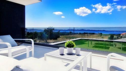 a living room with a view of a golf course at Villa 1 in Kožino