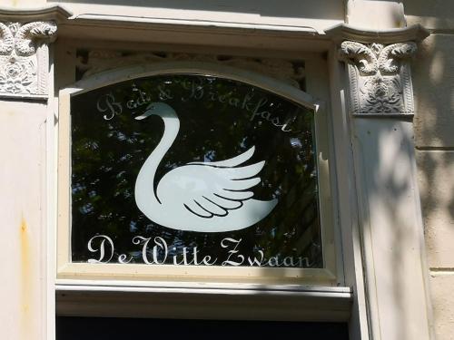 a swan sign on a window of a building at De WitteZwaan in Harlingen