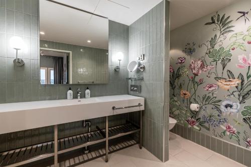 a bathroom with a sink and a mirror at Scandic Eden Nokia in Nokia