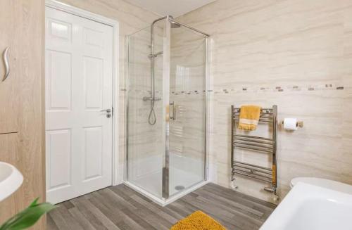 a bathroom with a shower with a glass door at Oxheys Stays - Sleeps 7 - Home from Home in Preston