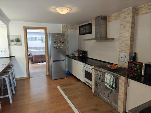 a kitchen with a stainless steel refrigerator in a room at Casa Diego in Melias