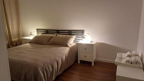 a bedroom with a bed with two night stands and two lamps at Casa Maricciotti in Terni