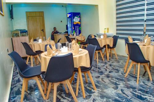 a row of tables and chairs in a restaurant at Bremmy Multilinks Hotels and Suites in Asaba