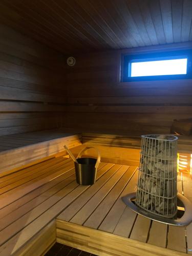 a bucket in the inside of a sauna at Lapland Riverside Home in Rovaniemi