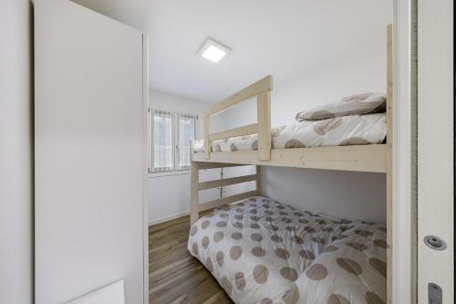 a bedroom with two bunk beds and a window at Vivere il Parco in Lonato