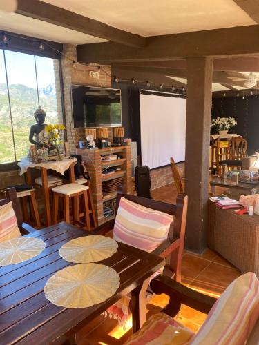 a living room with a wooden table and chairs at Natura Escapade Guesthouse in Torrox