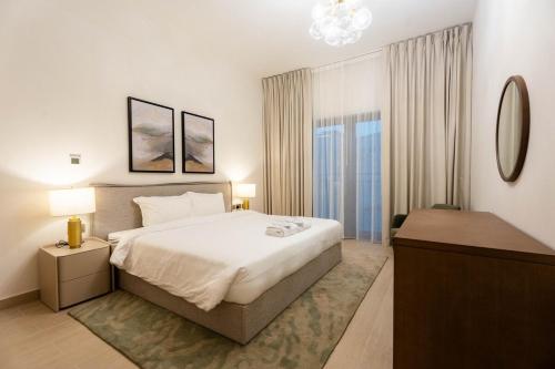 ein Schlafzimmer mit einem großen Bett und einer Kommode darin in der Unterkunft Yas Golf Collection 1 BR Near Theme Parks in Abu Dhabi
