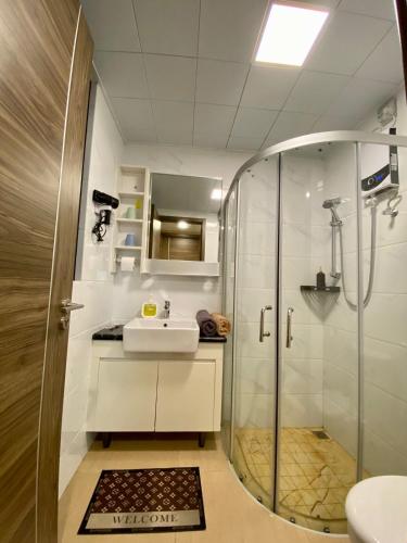 a bathroom with a shower and a sink at Skyhouse bsd tower duxton 2 in Samporo