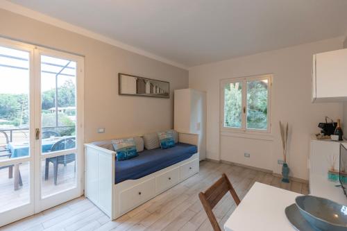 a living room with a bed and a balcony at Appartamento Pino Fetovaia by ElbaSummer Tour Operator in Fetovaia
