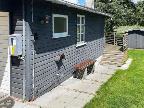 a blue house with a bench and a window at 4 person holiday home in Haderslev in Haderslev