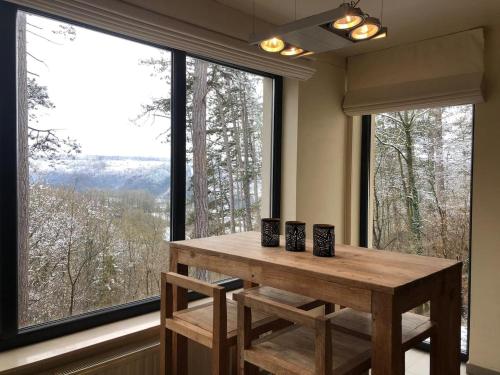 a table in a room with a large window at Modern holiday home 5 rooms in Durbuy