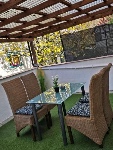 a glass table and two chairs on a patio at Mary Haus in Blasbach