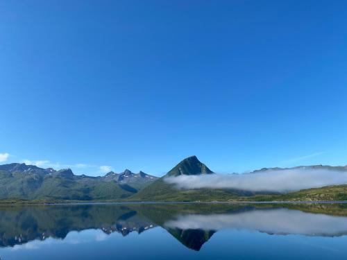 a view of crater lake in the mountains at Charming cabin by the sea in Lofoten in Sandsletta