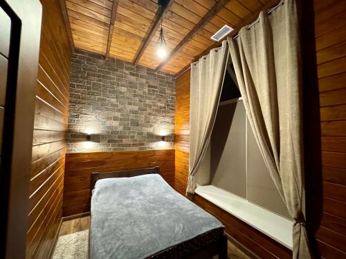 a small room with a bed and a window at Casa Cedru in Ialoveni