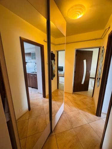 a view of a hallway with a mirror in a room at Apartament ultracentral in Craiova