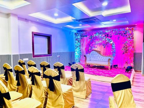 a room with rows of chairs in front of a stage at Pratima Heritage in Bhubaneshwar