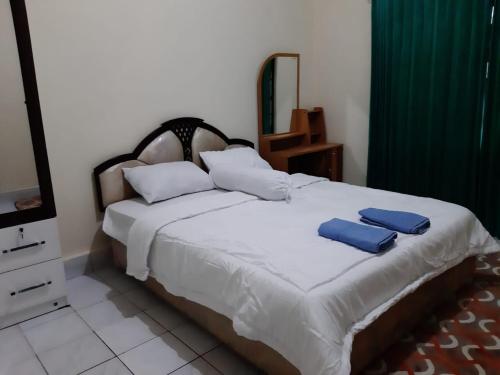 Postel nebo postele na pokoji v ubytování OYO 94930 Yetelu Guest House