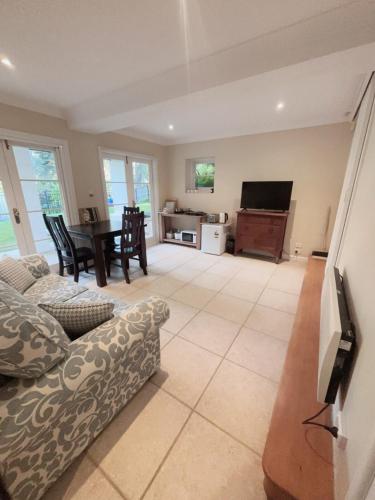 a living room with a couch and a table at Self-contained unit in Wahroonga in Warrawee