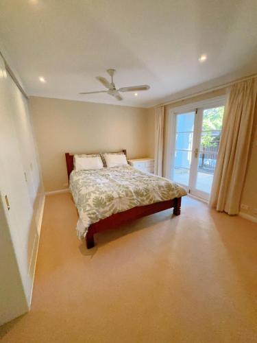 a bedroom with a bed and a ceiling fan at Self-contained unit in Wahroonga in Warrawee