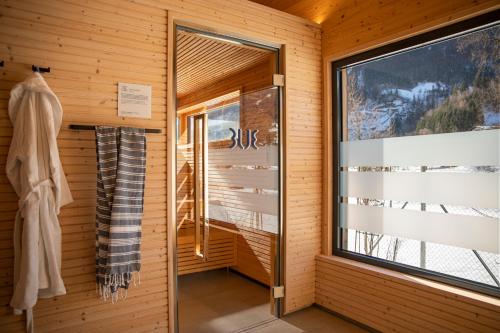 a room with a window in a wooden wall at TUI BLUE Montafon in Schruns