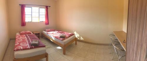 a room with two beds and a window at steps Self-Catering Accommodation in Okakarara