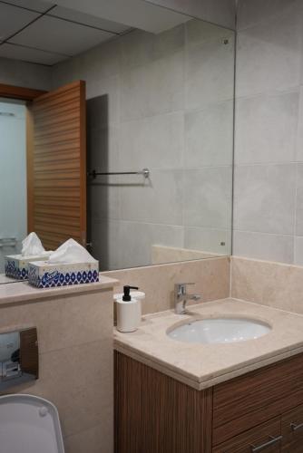 a bathroom with a sink and a mirror at Marjan Escape Studio in Dubai