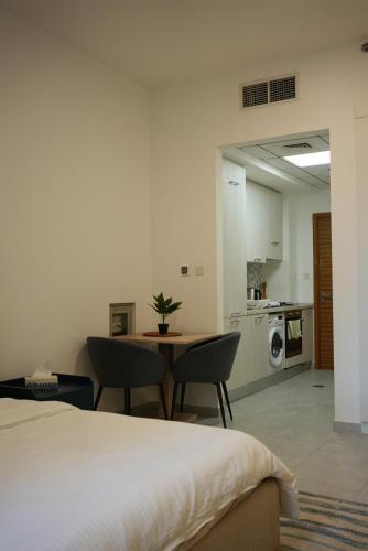 a bedroom with a bed and a table and chairs at Marjan Escape Studio in Dubai