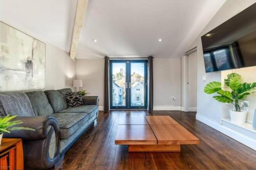 a living room with a couch and a coffee table at Quiet Victorian flat, Gloucester Road, fast wifi in Bristol