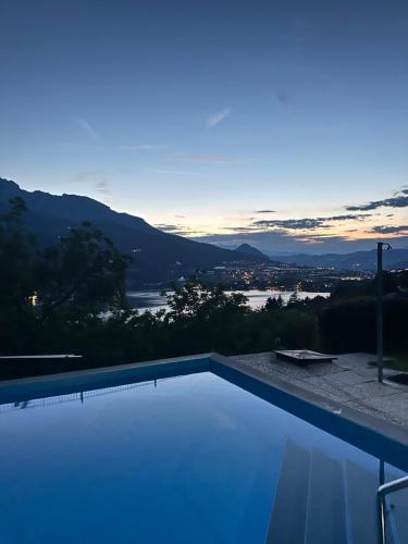 a swimming pool with a view of the water at Lake Apartment Gold, Lago di Caldonazzo in Tenna 