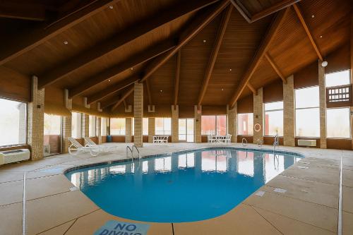 a large swimming pool in a large building with windows at Days Inn by Wyndham Jackson in Jackson