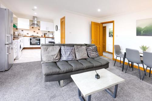 フォレスにあるForres Nightsのソファとキッチンのあるリビングルーム