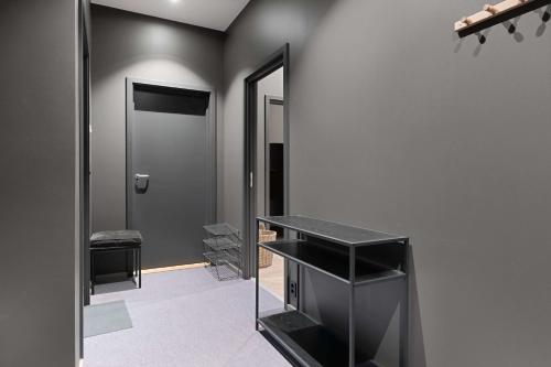 a dressing room with a mirror and a black shelf at Trysil Alpine Lodge in Trysil