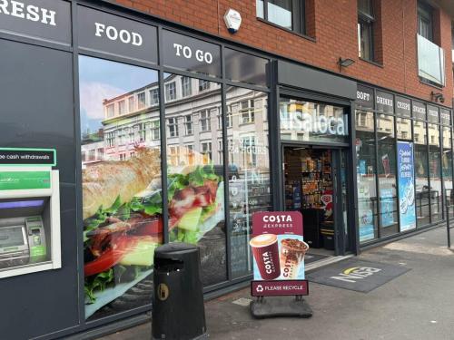 a food store with a large display window at Joyful Management - Riverview 1 bedroom Apartment 10 min to City Centre in Manchester