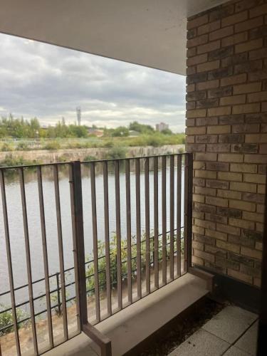 a balcony with a view of a river at Joyful Group - Stylish 2 Bedroom Duplex with Sofa Bed in Salford M5 in Manchester