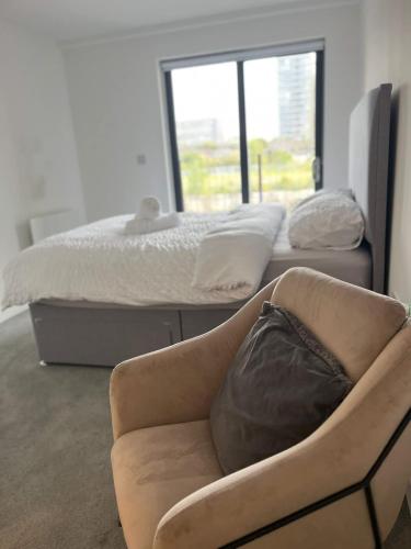 a living room with a couch and a bed at Joyful Group - Stylish 2 Bedroom Duplex with Sofa Bed in Salford M5 in Manchester