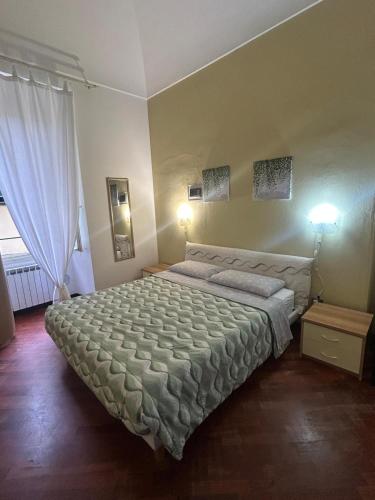 a bedroom with a large bed and a window at Larysa in Sanremo