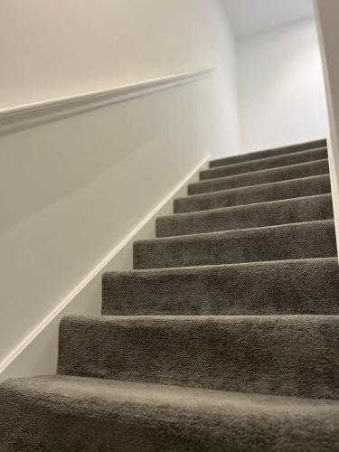 a set of stairs in a house at Joyful Group - Stylish 2 Bedroom Duplex with Sofa Bed in Salford M5 in Manchester
