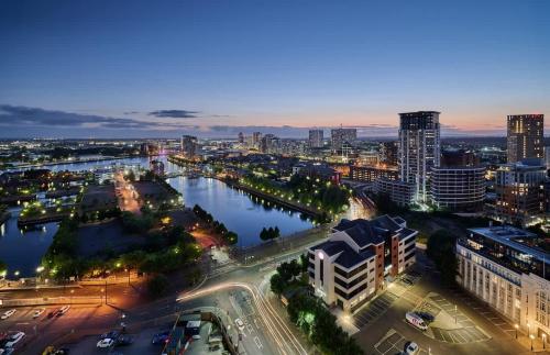 an aerial view of a city at night at 2 bed ensuite with fantastic night view and Old Trafford Stadium in Manchester