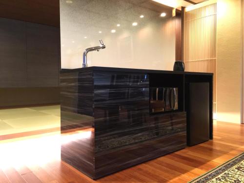 a bathroom with a sink and a faucet at Hananobou Kinkakuji-michi in Kyoto