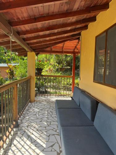 a porch with a wooden pergola and benches at Cascadia in Cocorná