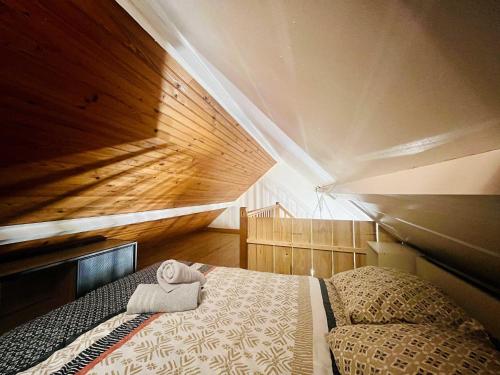 a bedroom with a bed with a towel on it at La Grange in Carentan