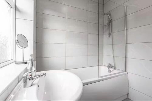 a bathroom with a sink and a shower with a mirror at Connaught Stays - Home from Home in Preston