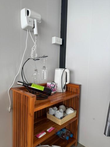 a shelf with a phone and other items on it at วิมานหมอก ภูทับเบิก in Ban Maeo Thap Boek