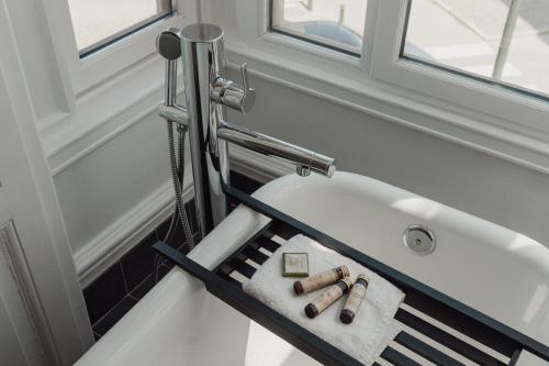 a bathroom with a bath tub with a shower at TwentySix in Malmö