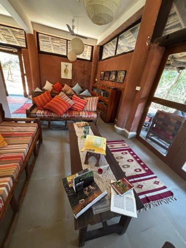 a living room with a couch and a table at Emerald Tiger Retreat in Tāla