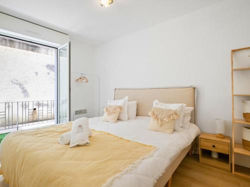 a bedroom with a large bed with a large window at Le Cocon - 5 min to Monaco - Ideal couple or business - Free private parking - Near events - Terrace and balcony - Premium services in Fontvieille
