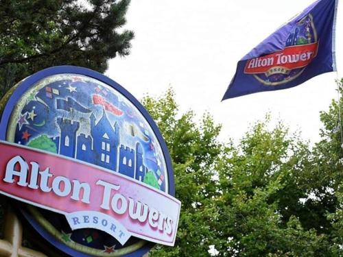a sign for an alton towers restaurant with a flag at The Stables in Alton